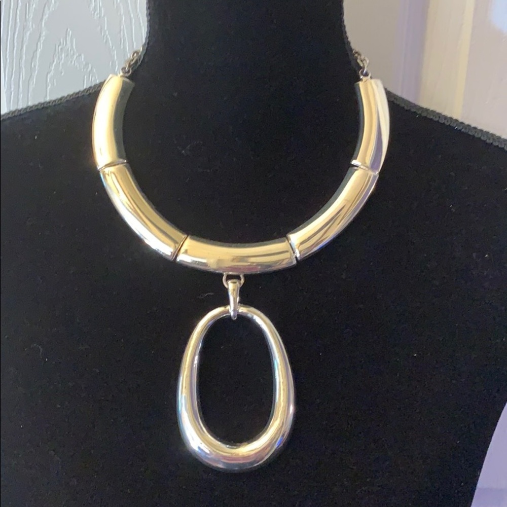 Silver necklace with chain closure.